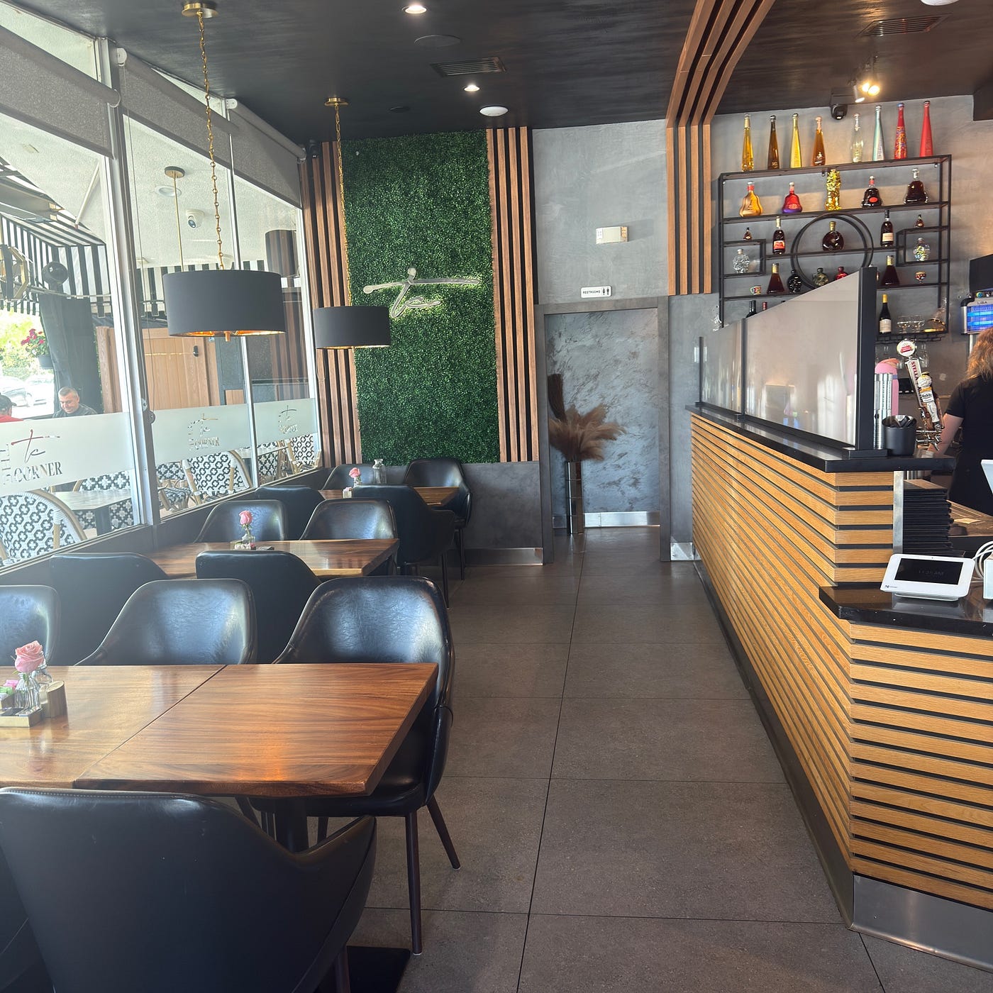 Interior of The Corner Lounge restaurant in Glendale, with dining tables and a wood-paneled bar