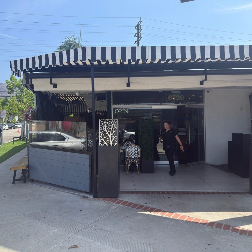 Exterior storefront of The Corner with an OPEN sign in the window